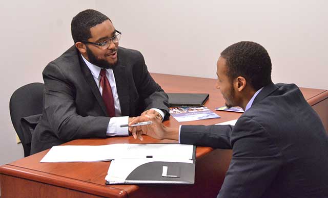 NC A&T State accounting graduate DeSean Jordan (left) conducts an interview with student Charles Chisley IV.